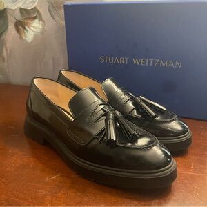 Stuart Weitzman black tassel loafers.